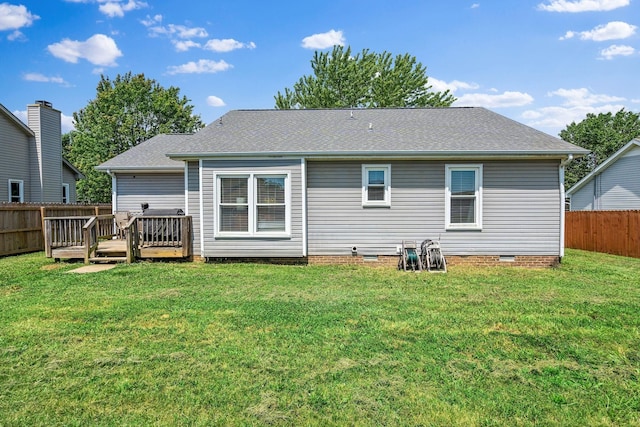 back of property featuring a lawn and a wooden deck