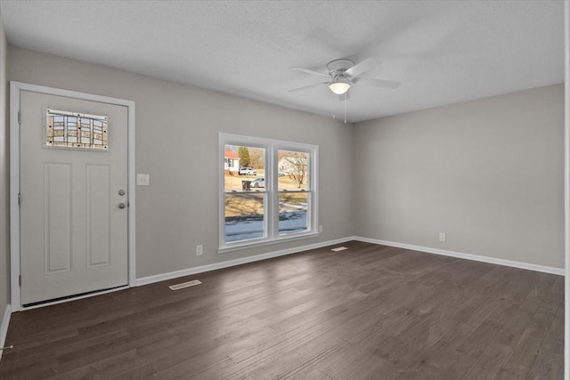 foyer featuring a textured ceiling, ceiling fan, and dark hardwood / wood-style floors