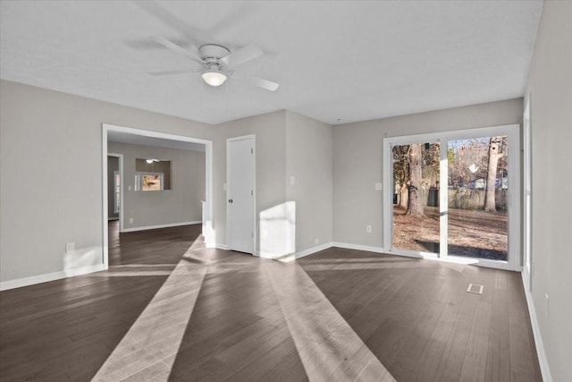 spare room featuring ceiling fan and dark hardwood / wood-style floors