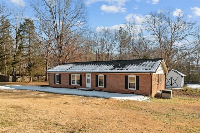 view of front of property with central AC unit and a front yard