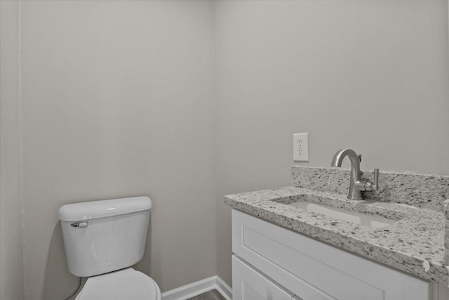 bathroom with toilet and vanity