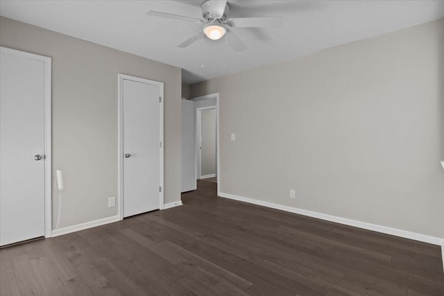 unfurnished bedroom with dark hardwood / wood-style flooring and ceiling fan