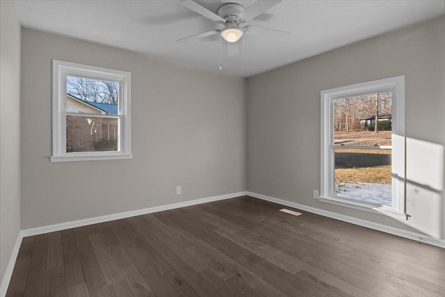 unfurnished room featuring ceiling fan and dark hardwood / wood-style flooring