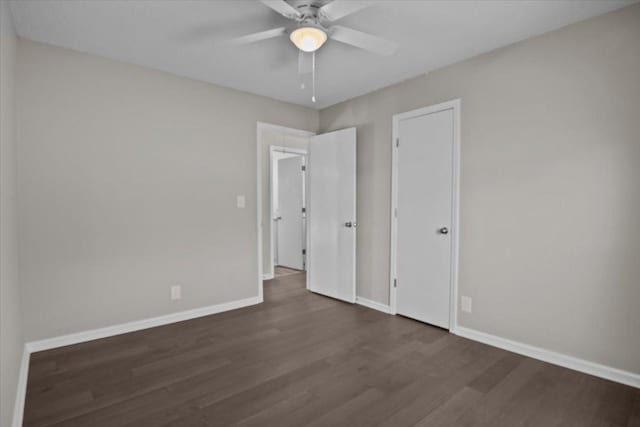 unfurnished bedroom featuring dark hardwood / wood-style flooring and ceiling fan