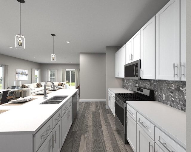 kitchen featuring stainless steel appliances, sink, white cabinetry, tasteful backsplash, and hanging light fixtures