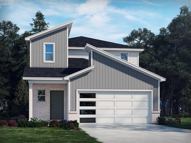 view of front of house featuring a front yard and a garage