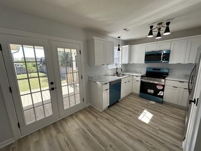 kitchen with sink, white cabinetry, light hardwood / wood-style floors, pendant lighting, and appliances with stainless steel finishes