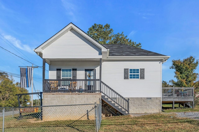 back of property featuring a porch and a lawn