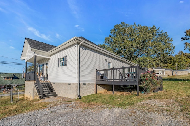 view of property exterior featuring a lawn and a wooden deck