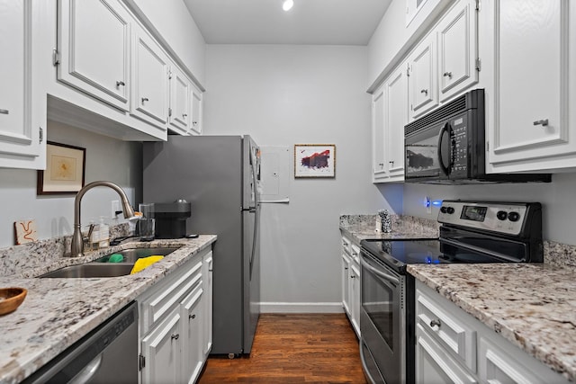 kitchen featuring stainless steel appliances, sink, white cabinetry, dark hardwood / wood-style floors, and light stone countertops