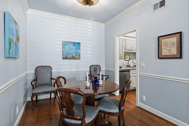 dining area with crown molding and dark hardwood / wood-style floors