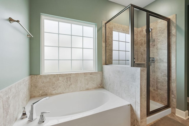 bathroom with tile patterned flooring, plenty of natural light, and plus walk in shower