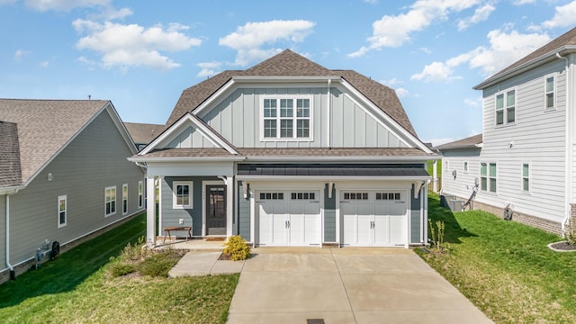 view of front of property with a front lawn and a garage