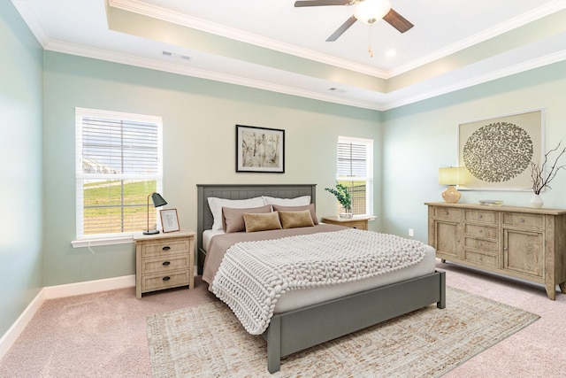 bedroom with crown molding, light colored carpet, a raised ceiling, and ceiling fan