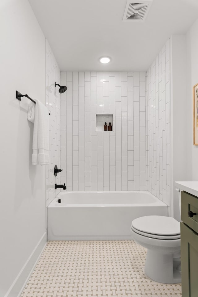 full bathroom with toilet, vanity, tile patterned flooring, and tiled shower / bath combo