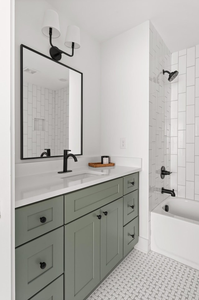 bathroom with vanity and tiled shower / bath