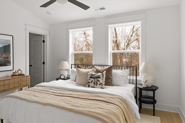 bedroom featuring lofted ceiling, hardwood / wood-style floors, and ceiling fan