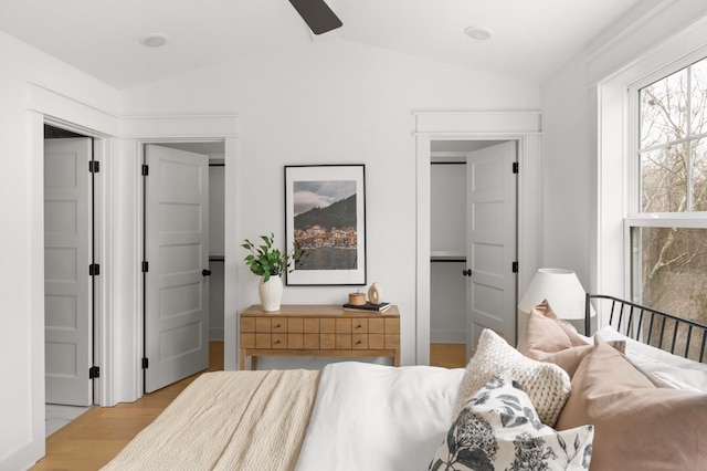 bedroom featuring ceiling fan, vaulted ceiling, and light hardwood / wood-style flooring