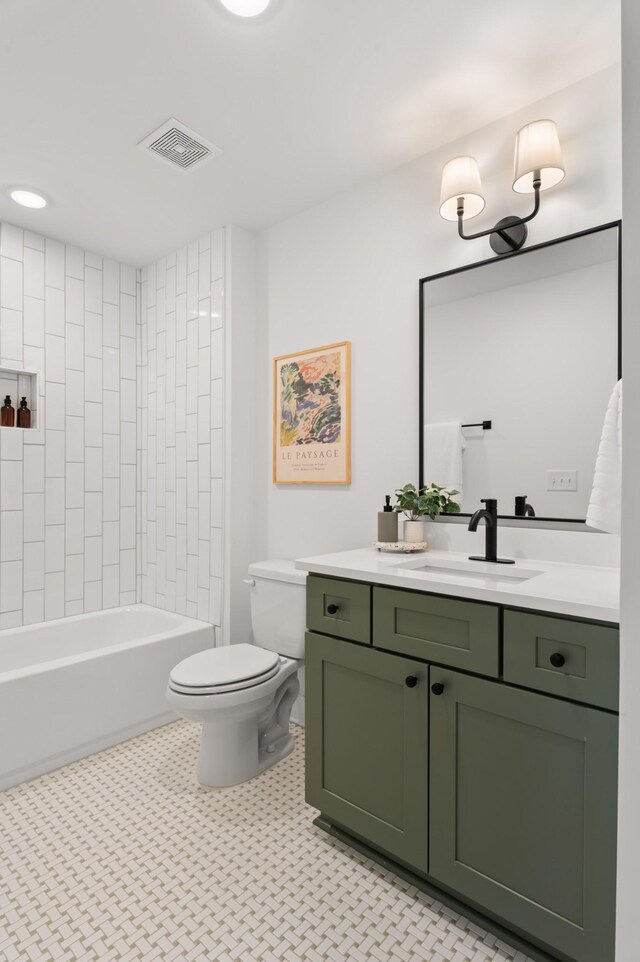 full bathroom with toilet, tiled shower / bath, and vanity