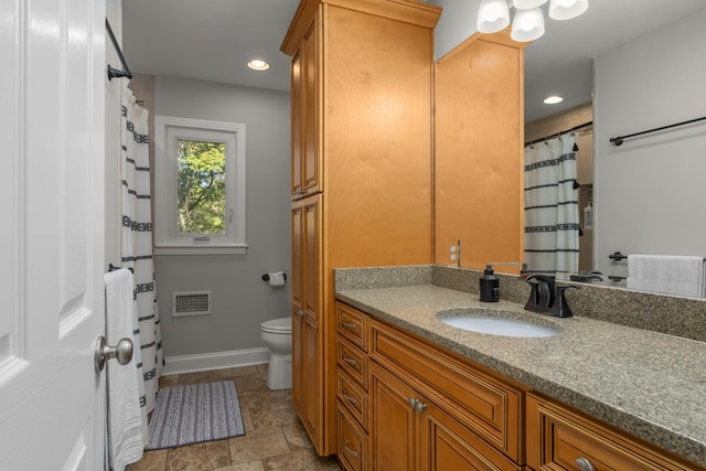 bathroom featuring toilet and vanity