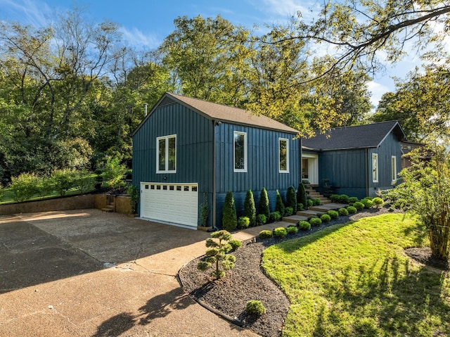 exterior space featuring a garage and a yard