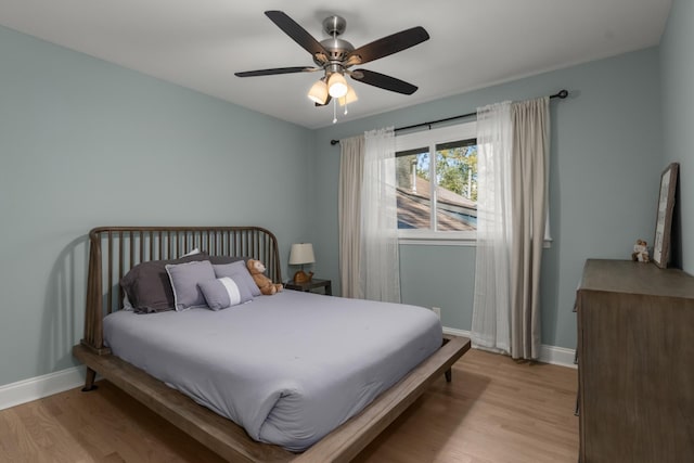 bedroom with ceiling fan and light hardwood / wood-style floors