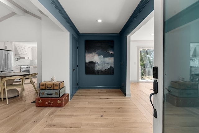 hallway featuring light wood-type flooring and crown molding