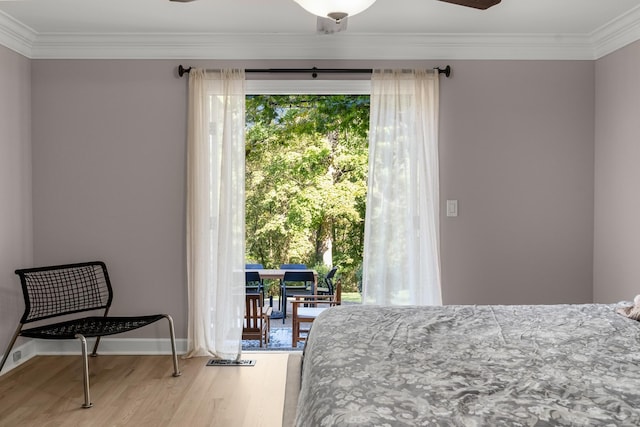 bedroom featuring ceiling fan, crown molding, and wood-type flooring