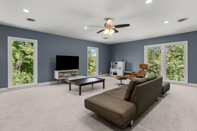 carpeted living room featuring ceiling fan