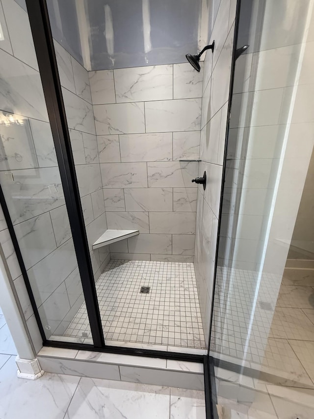 bathroom featuring a shower with shower door