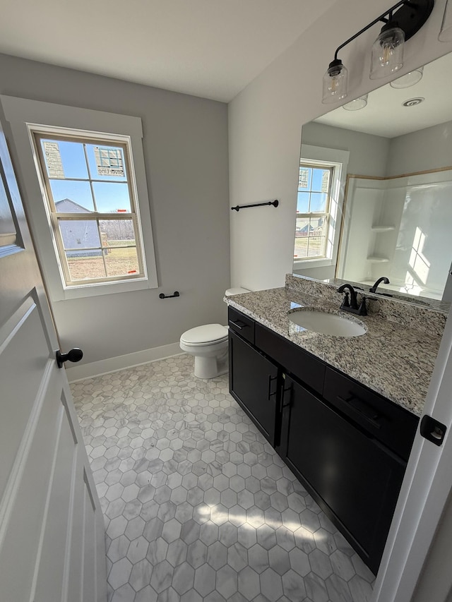 bathroom with vanity, a shower, tile patterned flooring, and toilet