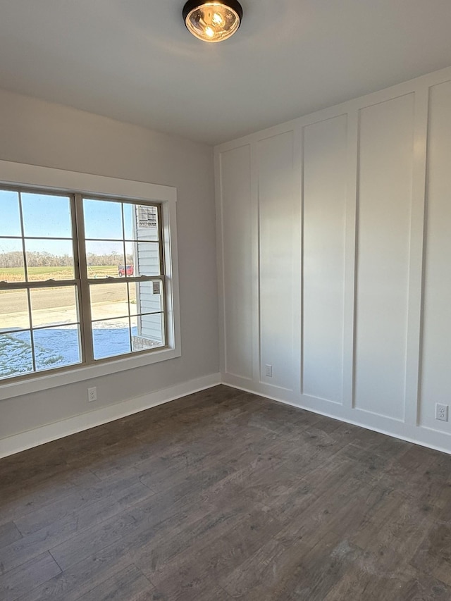 empty room with dark wood-type flooring