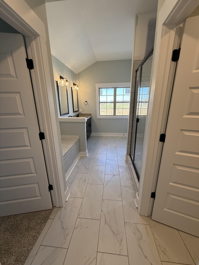 bathroom featuring an enclosed shower, vanity, and vaulted ceiling