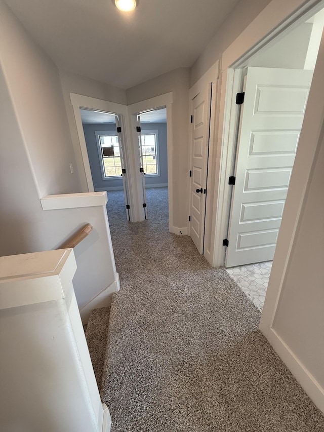 hallway featuring light carpet