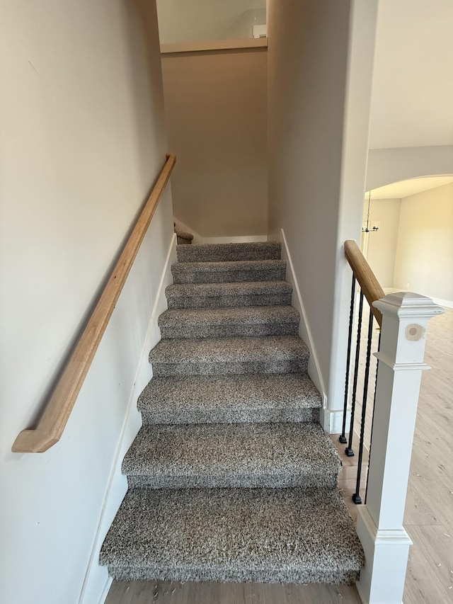 stairs featuring wood-type flooring