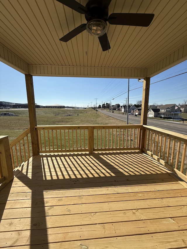 wooden deck featuring ceiling fan