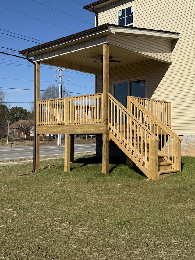 wooden terrace with a lawn and ceiling fan