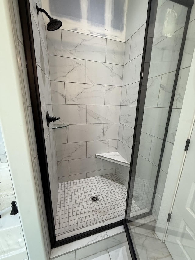 bathroom with a tile shower