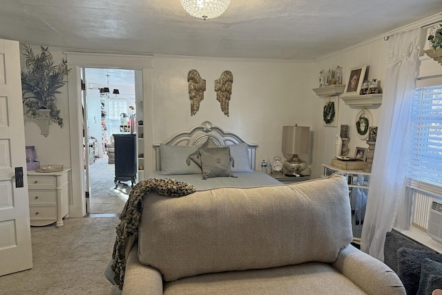 bedroom with multiple windows, ornamental molding, a textured ceiling, and carpet