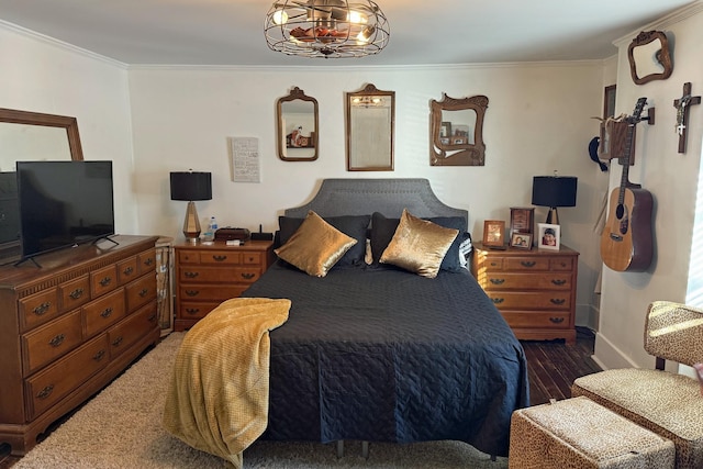 bedroom featuring dark hardwood / wood-style flooring and ornamental molding