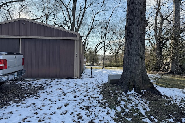 snowy yard with an outbuilding