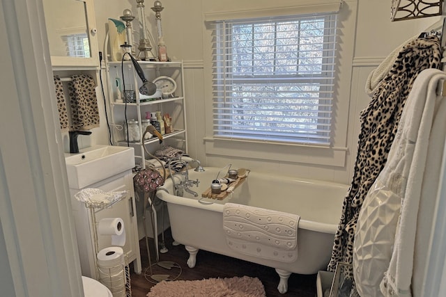 bathroom with sink and a tub to relax in