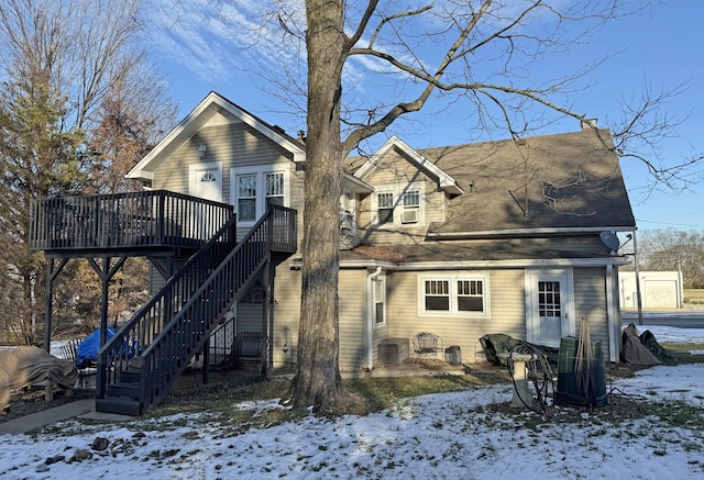 snow covered property featuring a wooden deck