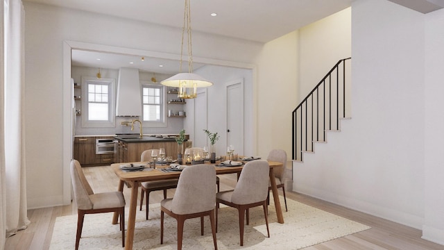 dining room with sink and light hardwood / wood-style floors