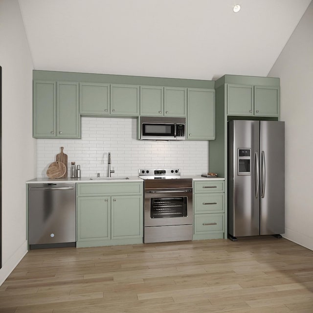 kitchen featuring light hardwood / wood-style flooring, green cabinets, stainless steel appliances, tasteful backsplash, and sink