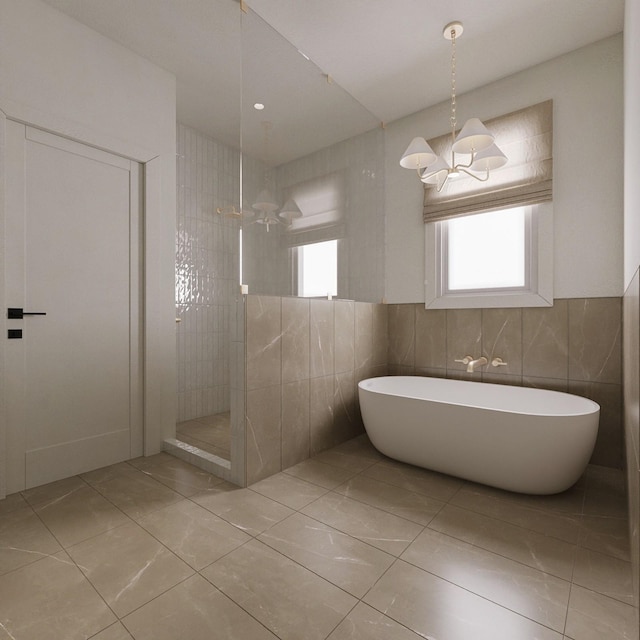 bathroom featuring tile walls, an inviting chandelier, and separate shower and tub