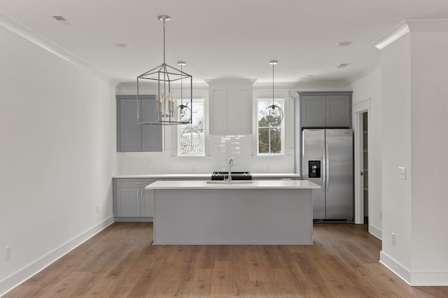 kitchen featuring gray cabinetry, sink, and stainless steel refrigerator with ice dispenser