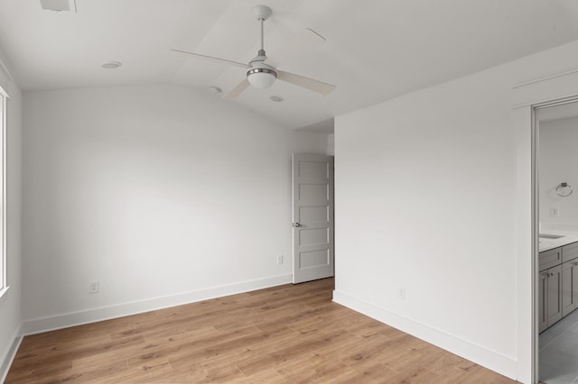 spare room featuring ceiling fan, vaulted ceiling, and light hardwood / wood-style flooring