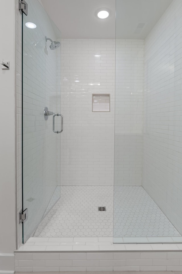 bathroom featuring a shower with door