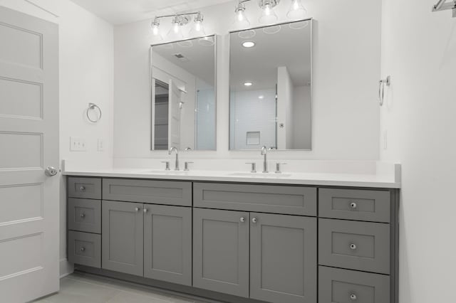 bathroom featuring tile patterned flooring and vanity